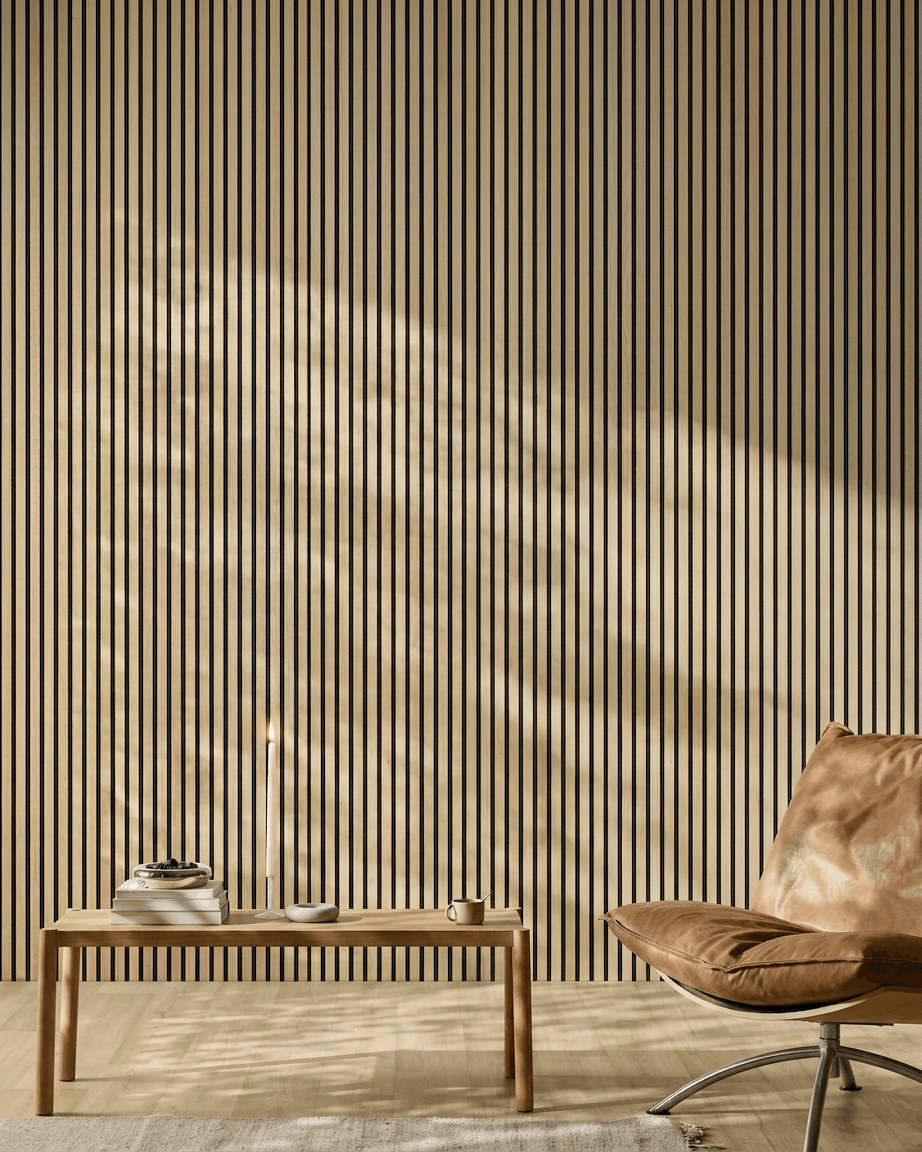 Minimalistyczne wnętrze z akustycznym panelem drewnianym WoodUpp Akupanel w wykończeniu Classic Oak, skórzanym fotelem, drewnianym stołem, świecą i światłem słonecznym rzucającym cienie.